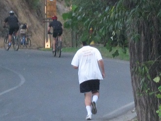 Hombre de jogging y ciclistas subiendo,
                          aqu� con cascos