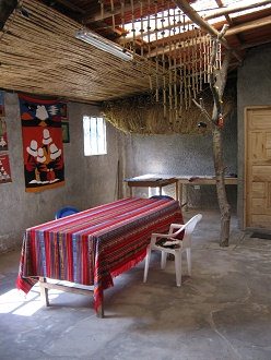 Tisch mit Tischdecke und
                                    Wandteppich im Hintergrund