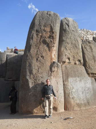 Cusco Sacsayhuamn, giant corner stone of the zigzag wall with tourists - with Michael Palomino as a size comparison