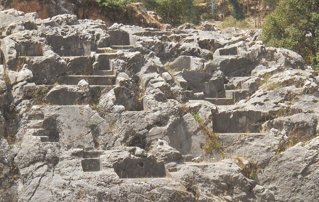 Cusco Sacsayhuam�n, rock of stairs and thrones "Chinchana grande", view 5 with many platforms and thrones, zoom with many thrones