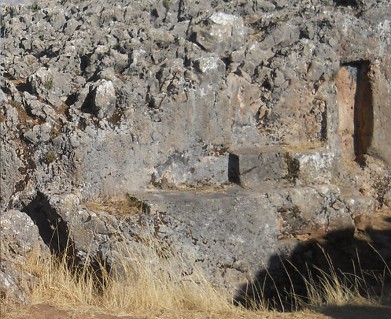 Cusco Sacsayhuam�n, even more mysteries: black and red rock walls of the corridor with niches and thrones 01 - zoom