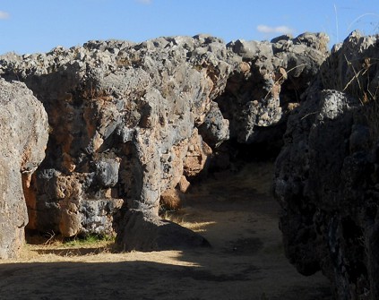 Cusco Sacsayhuam�n, even more mysteries: rock in black and red with column, zoom