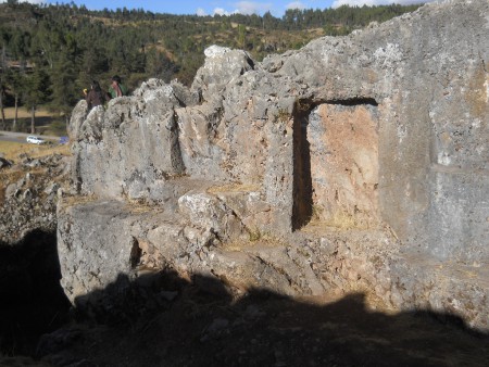 Cusco Sacsayhuam�n, even more mysteries: rock walls of the corridor in black and red with niches and thrones, zoom taken from the other side