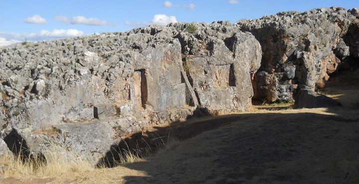 Cusco Sacsayhuam�n, even more mysteries: rock walls of the corridor in black and red with niches and thrones, panorama 04