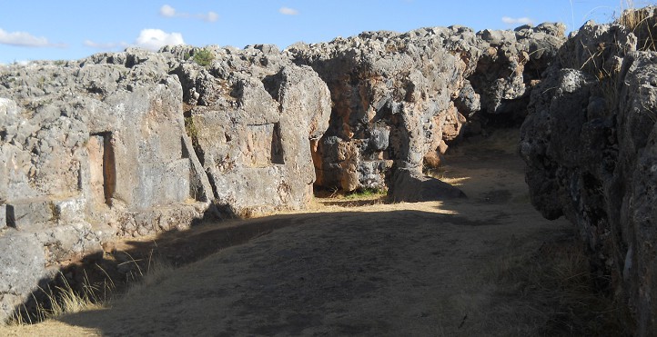 Cusco Sacsayhuam�n, even more mysteries: rock walls of the corridor in black and red with niches and thrones, panorama 05