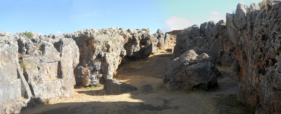 Cusco Sacsayhuam�n, even more mysteries: rock walls of the corridor in black and red with niches and thrones, panorama