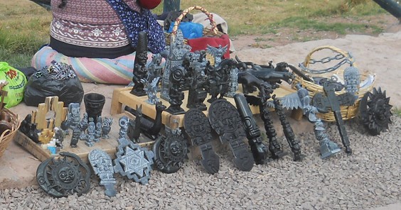 Cusco Sacsayhuam�n, near the big parking: peddlers with figurines as memories, zoom 02 with sun, moon, snake, tumi knife, Mother Earth Cross, lamas, extraterrestrials with long skull and ball eyes etc.