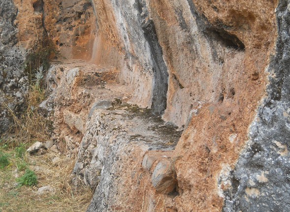 Cusco Sacsayhuamn, Zone X (Laq'o, Laco, Mondtempel), aus schwarz-rotem Fels geschnittene Sitzbank 03 - Nahaufnahme