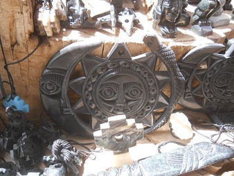 Handicraft workshop in Cusco Sacsayhuam�n:
                    combination of figurines with a moon with a face,
                    with a sun with a face, and with a snake 02