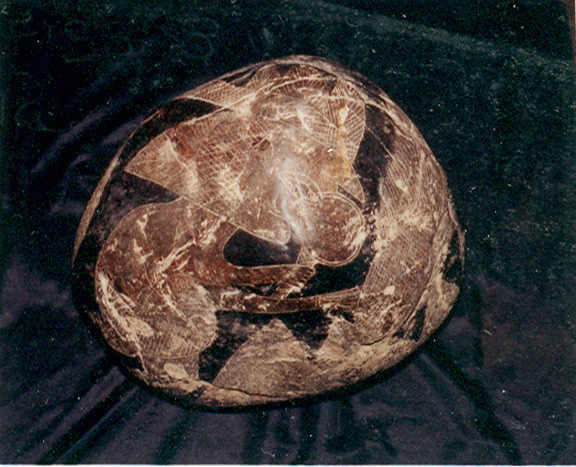 Here is another stone
                          showing a wise man with a magnifying glass and
                          an egg of the creation.